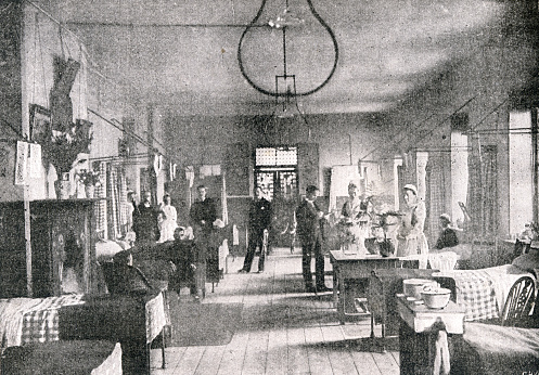 Medical doctors and nurses inside a London ward with patients.