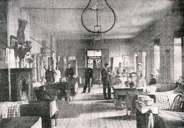 London Hospital Ward Interior in the late 19th Century Medical doctors and nurses inside a London ward with patients. 19th century stock illustrations