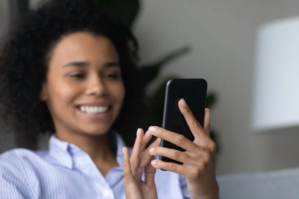 istock Happy millennial African woman using cellphone at home. 1402192414