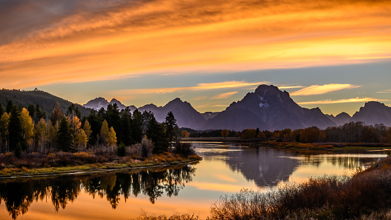 Mount Moran view from Oxbow Bend beside Snake River of Grand Teton, Wyoming. Color of tees and environment changing due to autumn change to winter.