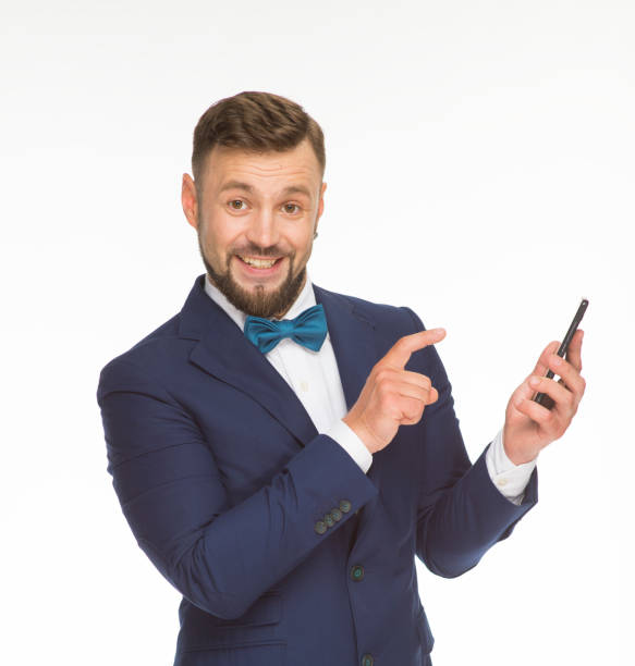 istock cheerful guy with a phone and a blue folder posing in a blue jacket on a white background isolated in the studio 1402194340