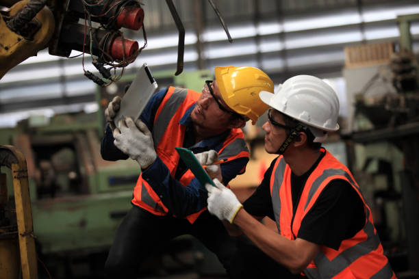 istock Industrial Engineers with machine.production engineer in industry. He checking or push metalwork control in industrial factory for  Concept Successful of Work. 1402194433