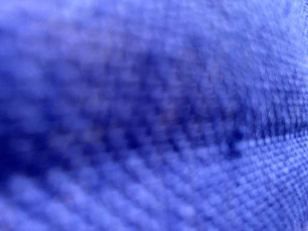 A blurry macro image of a blue braided fabric as a texture or background.