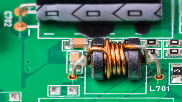 istock Green PCB detail with electromagnetic coil and electronic surface-mount components 1402195305