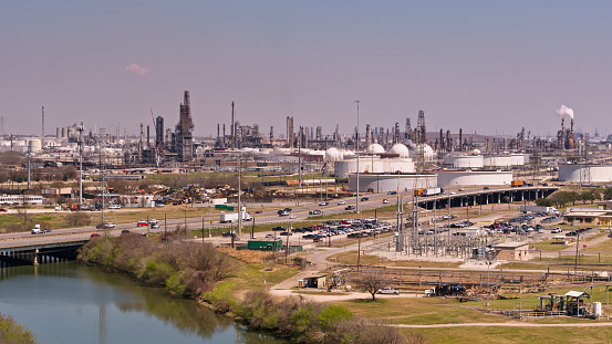 Aerial shot of I-45 passing petrochemical plant in Houston, Texas on a sunny afternoon.\n\nAuthorization was obtained from the FAA for this operation in restricted airspace