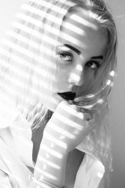 istock girl with blinds 1402197102