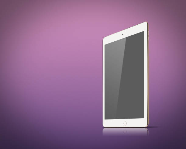 tablet pc with apple and coffee cup with reflections on table