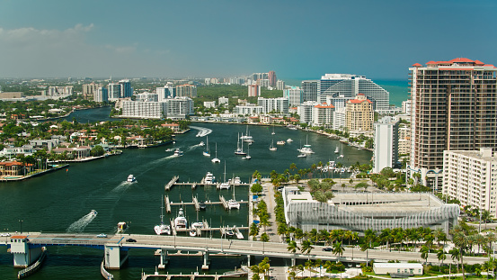 Aerial shot of boats on the Intracoastal Waterway in Fort Lauderdale, Florida on a sunny day. \n\nAuthorization was obtained from the FAA for this operation in restricted airspace.