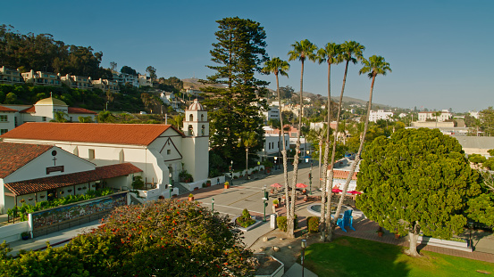 Aerial shot of downtown Ventura, California on a sunny afternoon, flying over the pedestrianized Main Street near the Mission San Buenaventura.