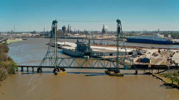 Aerial View of Port Facilities in Beaumont, Texas Aerial establishing shot of a freight train crossing the Neches River in Beaumont, Texas on a clear sunny afternoon. beaumont tx stock pictures, royalty-free photos & images