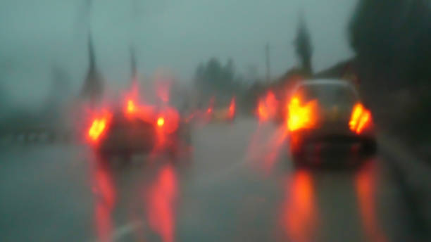 Traffic from car to stormy day Highway traffic blur seen from inside car with car taillights on in heavy rain storm - Traffic Blur on motorway seen from inside car with car taillights on in a heavy rainstorm lluvia stock pictures, royalty-free photos & images