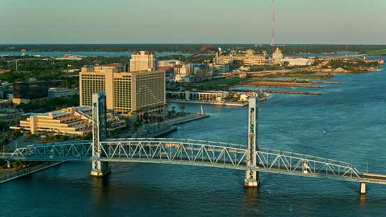 Drone shot of the Main Street Bridge, officially the John T. Alsop Jr. Bridge, crossing the St. Johns River in Jacksonville, Florida at sunset.