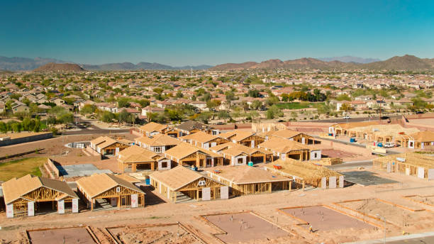 istock Foundations and Half Built Houses with Completed Suburban Homes Behind - Drone Shot 1402201339