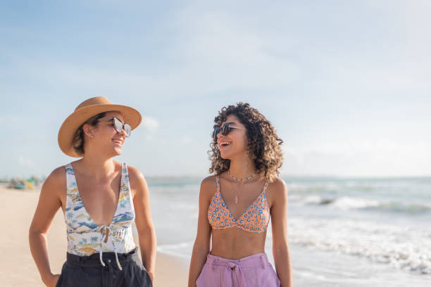 istock Mother and daughter walking along the beach 1402204534