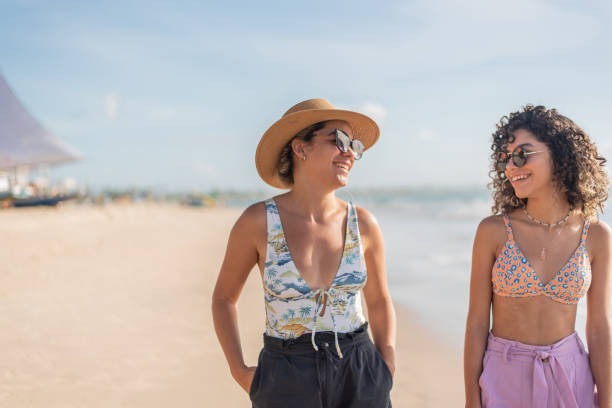 istock Mother and daughter walking along the beach 1402204538
