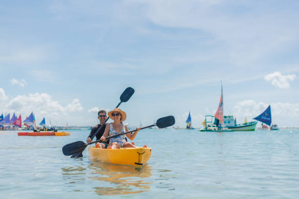 istock Couple with kayak on the beach 1402204573