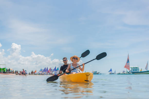 istock Couple with kayak on the beach 1402204578