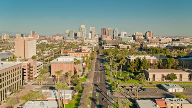Drone shot of Phoenix, Arizona on a sunny afternoon, looking along Adams Street past the House of Representatives towards downtown office towers.  \n\nAuthorization was obtained from the FAA for this operation in restricted airspace.