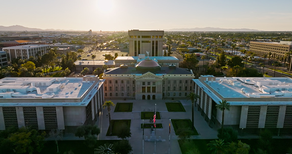 Aerial shot of the Arizona State Capitol Building, the State Senate and House of Representatives from over Wesley Bolin Memorial Plaza in Phoenix at sunset on a spring evening. \n\nAuthorization was obtained from the FAA for this operation in restricted airspace.