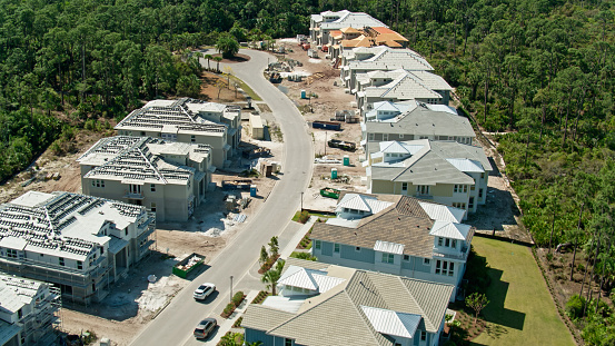Aerial shot of waterfront homes in Naples, Florida on a clear sunny day\n\nAuthorization was obtained from the FAA for this operation in restricted airspace.