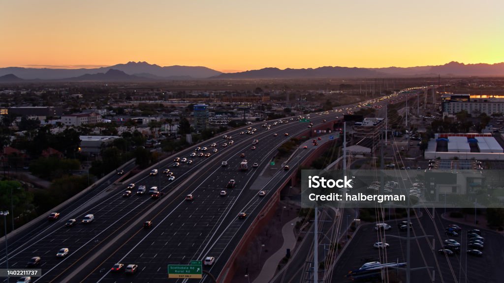 Morning Rush Hour on Loop 202 in Tempe, Arizona - Aerial Aerial shot of Loop 202, also known as the South Mountain Freeway, in Tempe, a city in the Phoenix metropolitan area at sunrise on a spring morning. 

Authorization was obtained from the FAA for this operation in restricted airspace. Flying Stock Photo