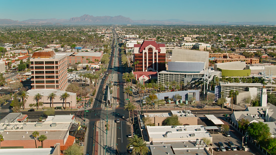 Aerial shot of Mesa, a city within the Phoenix metropolitan area, on a sunny day in spring, including Valley Metro light rail system tracks along Main Street.