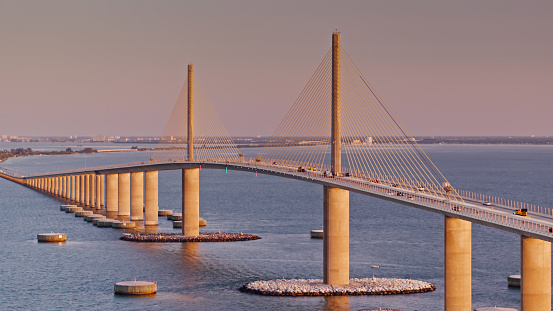Drone shot of the Sunshine Skyway Bridge, a 4.14 mile series of bridges across Lower Tampa Bay in Florida at sunrise.