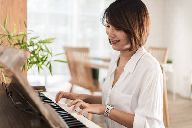 istock women playing piano 1402216770