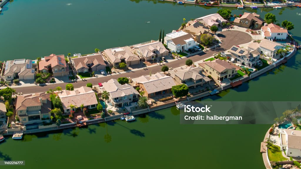 Lake Built Around Residential Cul-de-Sac in Glendale, AZ - Aerial Drone shot of residential streets built around an artificial lake in the Arrowhead Ranch neighborhood of Glendale, a suburb of Phoenix, Arizona. 

Authorization was obtained from the FAA for this operation in restricted airspace. Arizona Stock Photo