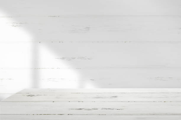 istock Background with white wooden walls and window lights shining on the table 1402220006
