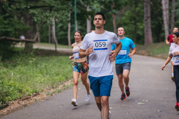 istock Large group of mixed age marathon runners racing on asphalt road 1402226088