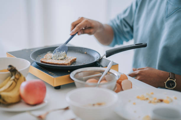 istock close up asian indian man cooking breakfast at apartment kitchen during weekend 1402227147