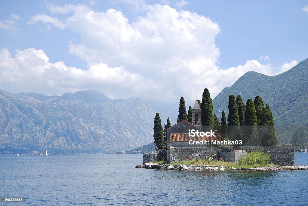 Old church on island Old church with a belltower on island in the lake, fenced with a wall Beauty Stock Photo