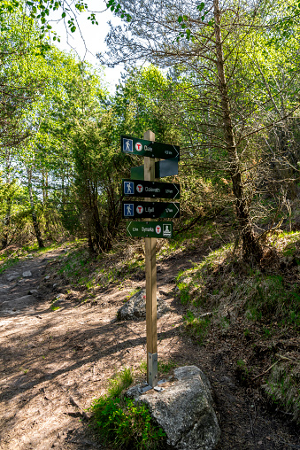 An arrow sign with route distances length and directions on a hiking trek to Lifjel mountain, Sandnes, Norway, May 2018