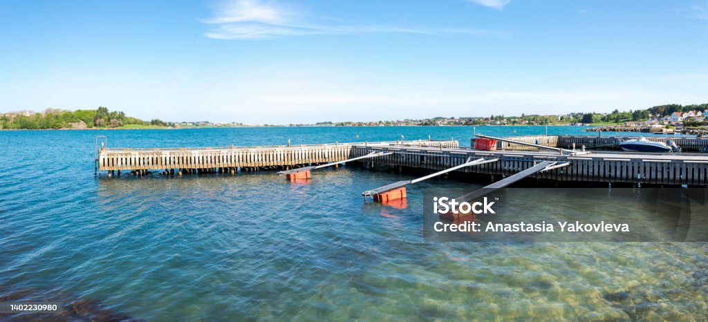 Boats safe parking area at wooden jetties in Hafrsfjord residential suburb area Boats safe parking area at wooden jetties in Hafrsfjord residential suburb area, Stavanger, Norway, May 2018 Bay of Water Stock Photo