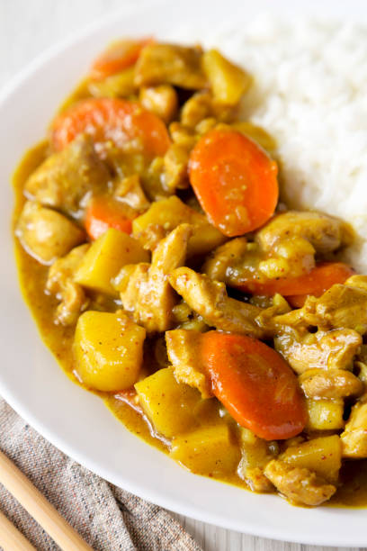 istock Homemade Japanese Chicken Curry  on a white plate, side view. Close-up. 1402231825