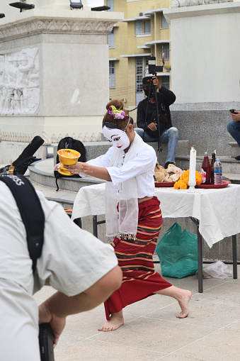 Bangkok Thailand - May 5 , 2022 :  White Myanmar  Mask dancing in public spaces by the women at the Democracy Monument on Ratchadamnoen Avenue