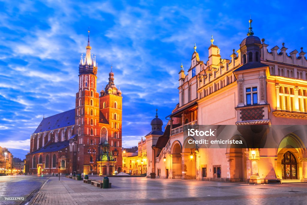 Krakow, Poland - Medieval Ryenek Square, Cloth Hall and Cathedral Krakow, Poland. St Mary's church and Cloth Hall on Main Market Square in Cracovia, illuminated in the night Krakow Stock Photo