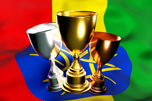 3d illustration of a cup of gold, silver and bronze winners on the background of the national flag of Ethiopia 3D visualization of an award for sporting achievements