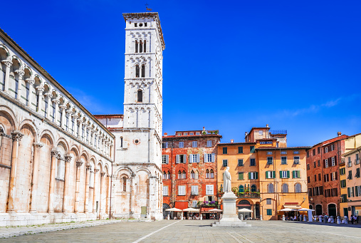 Lucca, Italy. Church San Michele in Foro, historical centre of old medieval town Lucca in summer day with clear blue sky, Tuscany.
