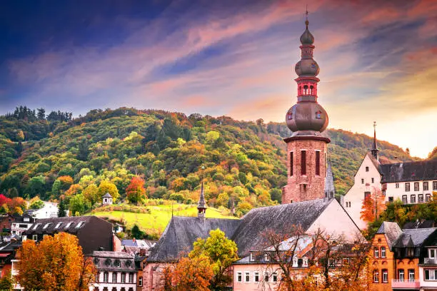 Cochem, Germany. Colored sunset with romantic Moselle River valley, Rhineland-Palatinate in red autumn colors.