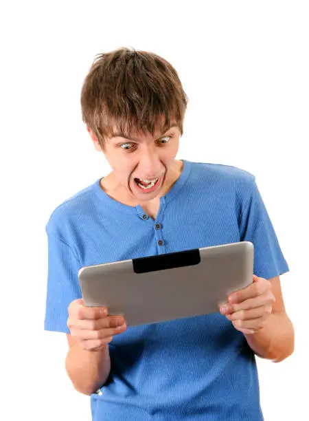 Angry Young Man with Tablet Computer Isolated on the White Background