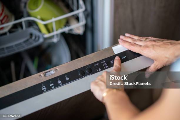 Closeup Of Woman Setting Cycle On Dishwasher Stock Photo - Download Image Now - Dishwasher, Push Button, Domestic Life