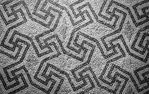 Swastika symbol in ancient Celtic mosaic decoration. Design for an old style background.