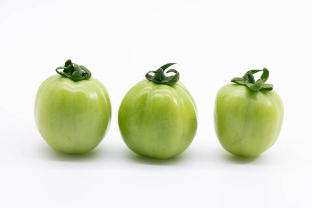 istock green unripe tomato isolated on white background 1402255111