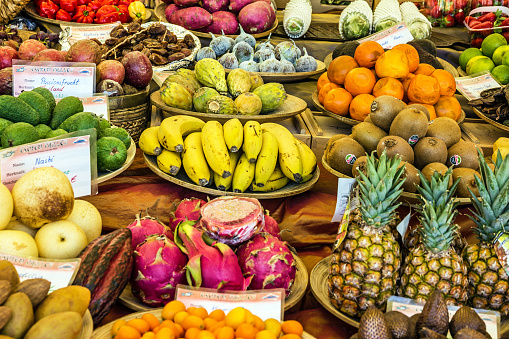 A colorful array of fruits and vegetable displayed for sale at the market\nHue, Vietnam