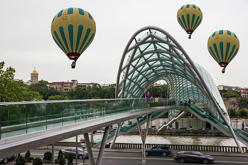 Tbilisi, Georgia - June 11, 2022: Tourist landmark - glass Bridge of Peace in Tbilisi.