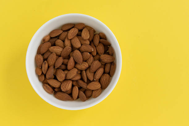 istock peeled almonds in bowl isolated on yellow background 1402262227