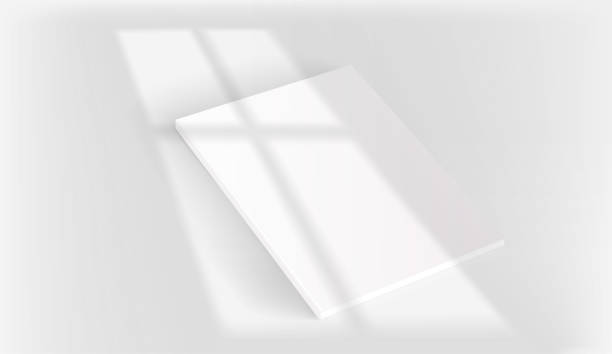 istock White book on a table with light of the window shadow overlay. Realistic vector mockup with sun flare effect 1402262504