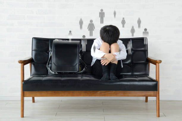 sitting child with human relationship troubles in school life - displeased child abandoned child abuse imagens e fotografias de stock